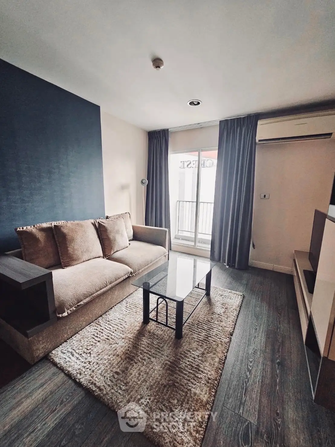 Modern living room with cozy sofa and large window in stylish apartment