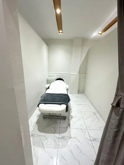 Modern minimalist room with sleek white decor and marble flooring