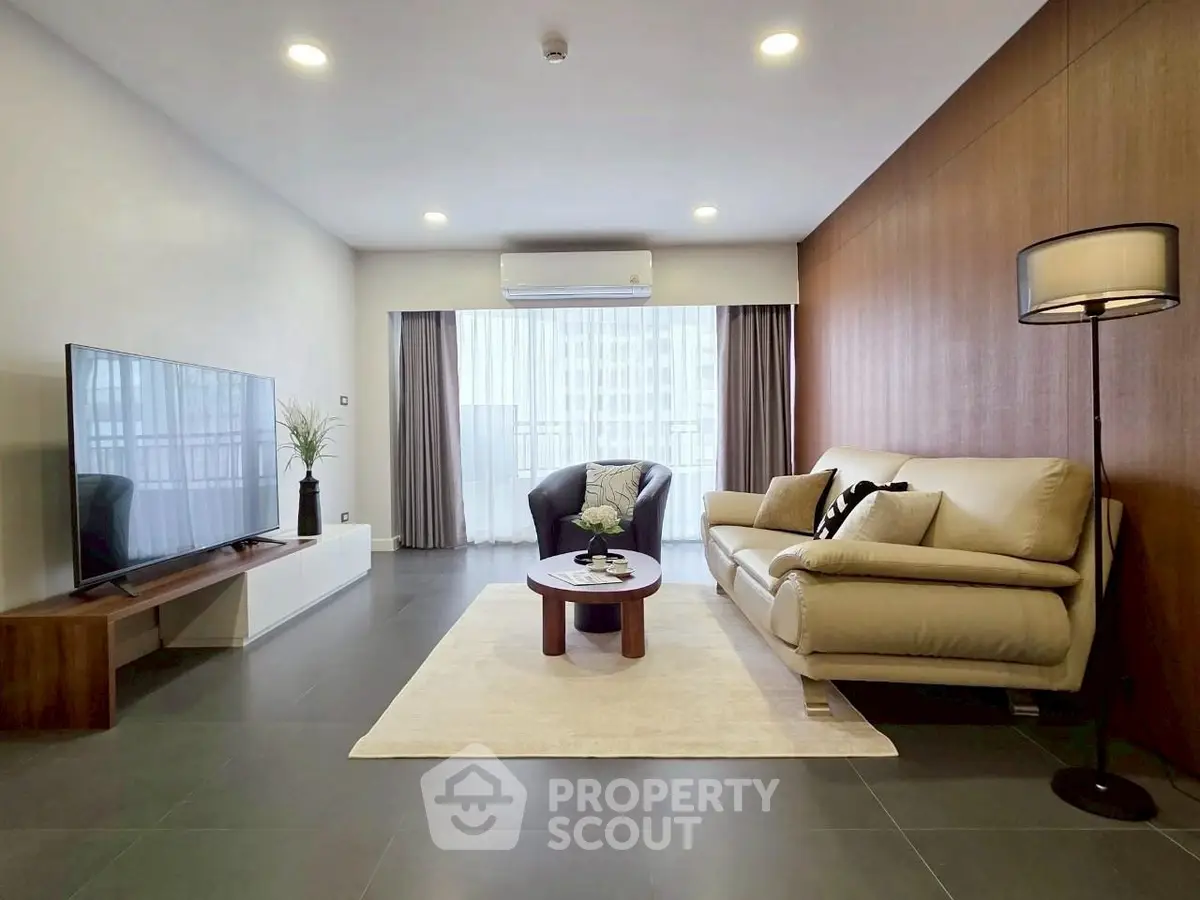 Spacious modern living room with elegant decor and large TV