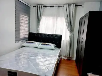 Cozy bedroom with modern decor and ample natural light