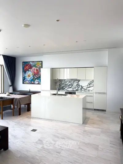 Luxurious modern kitchen with marble island and elegant dining area, featuring a stunning floral artwork.
