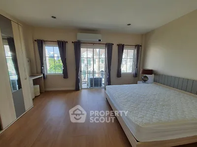 Spacious bedroom with large windows and modern furnishings
