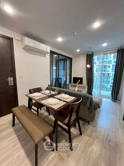 Modern living room with dining area and balcony view in a stylish apartment.