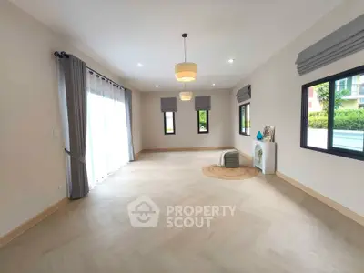 Spacious and bright living room with modern decor and large windows