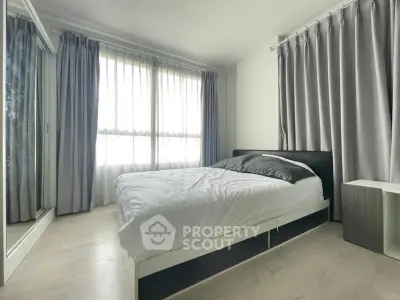 Spacious bedroom with large windows and modern decor