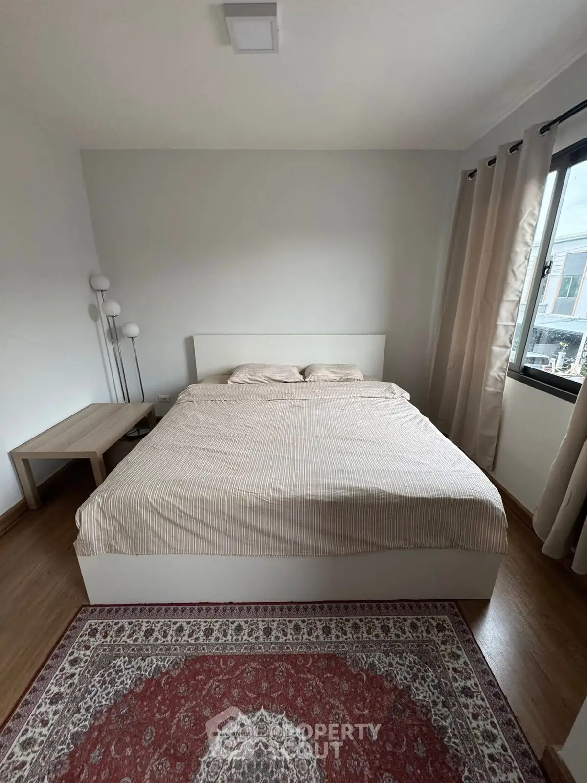 Spacious bedroom with large bed and elegant decor, perfect for relaxation.