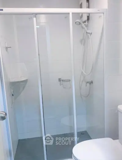 Modern bathroom with glass shower enclosure and sleek fixtures
