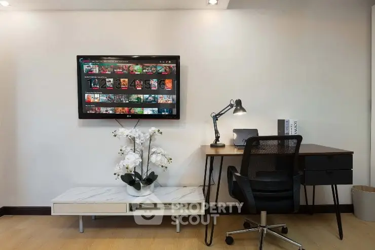 Modern study room with wall-mounted TV and stylish desk setup