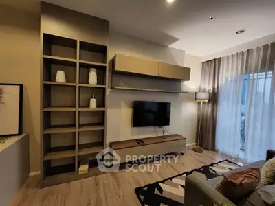 Modern living room with stylish shelving and wall-mounted TV, featuring elegant decor and natural light.