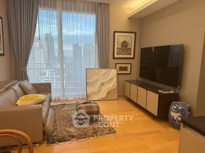 Modern living room with city view, stylish decor, and large TV