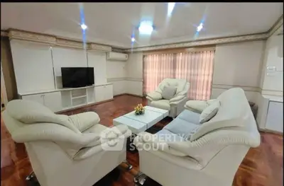 Spacious living room with elegant white leather sofas and modern decor
