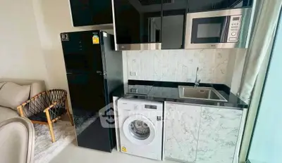 Modern kitchen with sleek appliances and stylish cabinetry in a contemporary apartment.