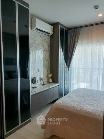 Modern bedroom with large windows and elegant decor in a high-rise apartment.