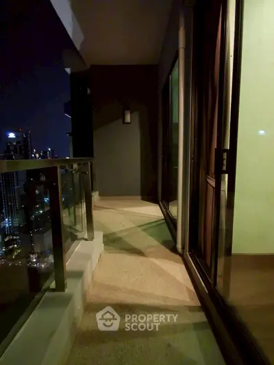 Stunning high-rise balcony with city skyline view at night, perfect for urban living.