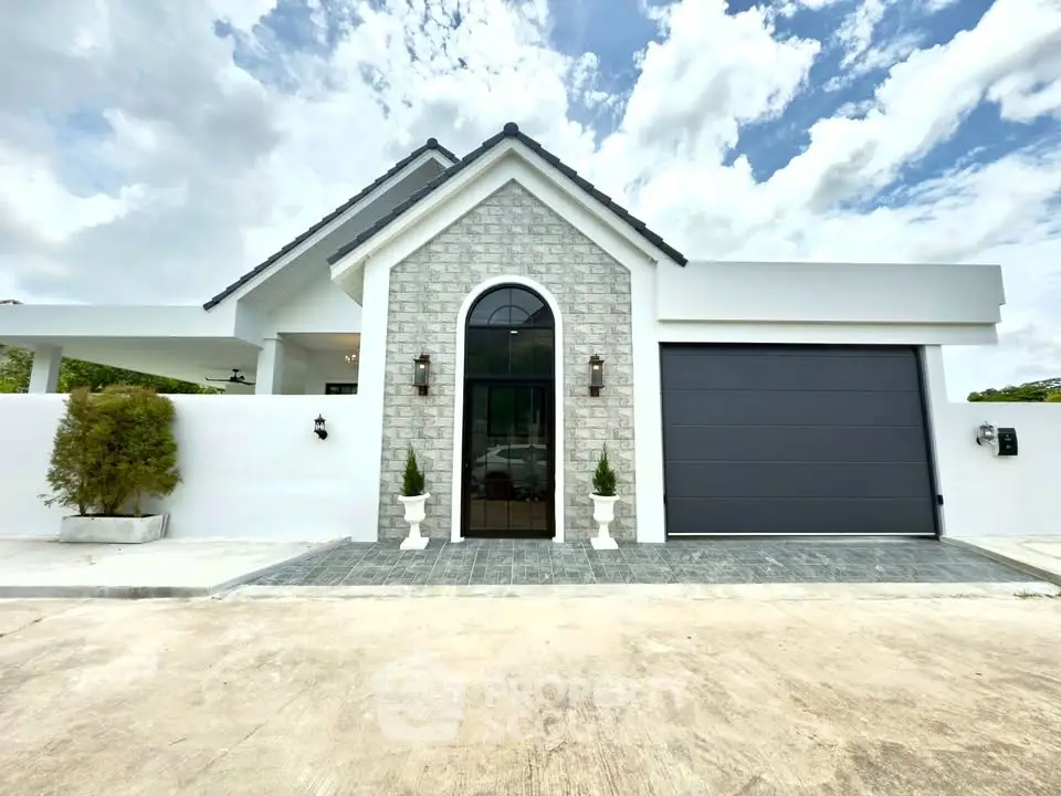 Stunning modern house exterior with elegant stone facade and sleek garage door.