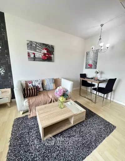 Charming living room with cozy seating and stylish decor, perfect for relaxation and entertaining.