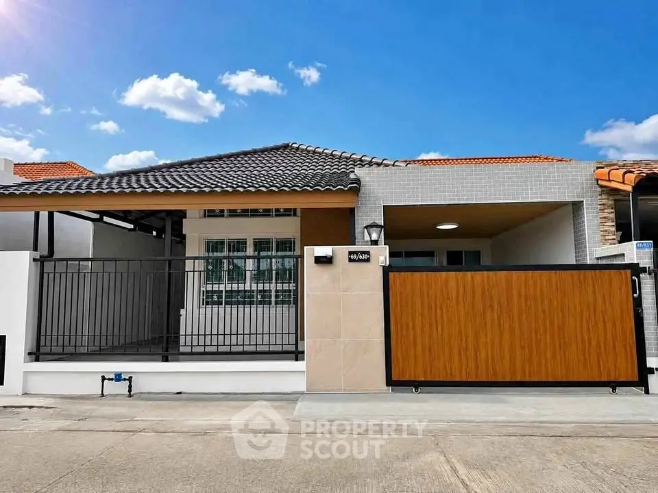 Charming single-story house with modern design and gated entrance in a serene neighborhood.