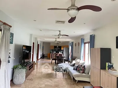 Spacious open-plan living room with modern decor and ceiling fans