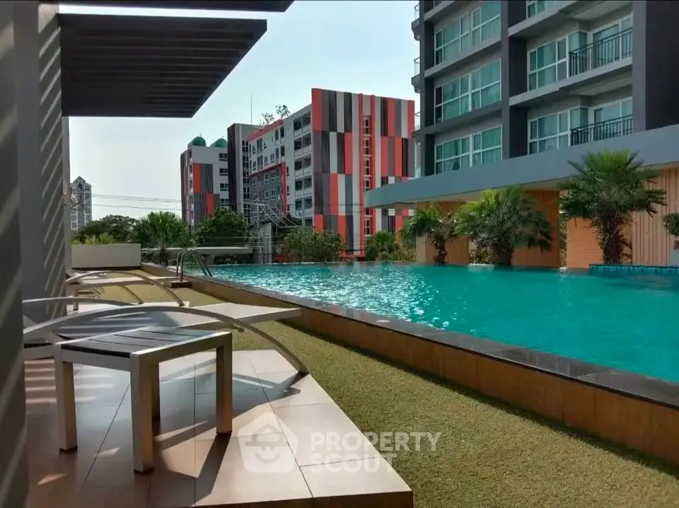 Luxurious apartment complex with a stunning outdoor pool and modern architecture.