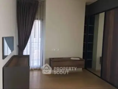 Modern bedroom with floor-to-ceiling window and sleek wooden furniture.