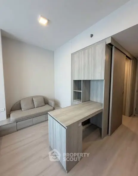 Modern living room with sleek wooden furniture and cozy sofa in a stylish apartment.