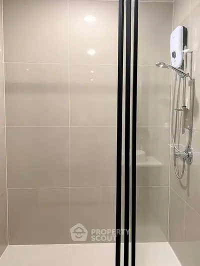 Modern bathroom with sleek shower design and neutral tiles, perfect for a contemporary home.