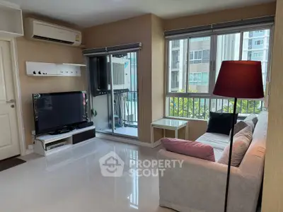 Modern living room with large windows and balcony access in urban apartment