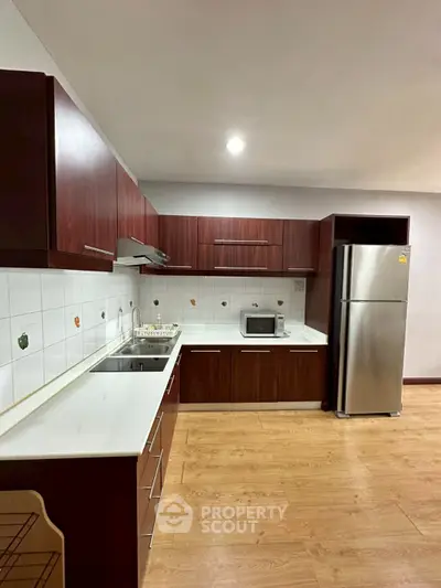 Modern kitchen with sleek wooden cabinets and stainless steel appliances