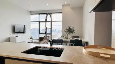 Modern open-layout kitchen with city view, featuring sleek countertops and contemporary fixtures.
