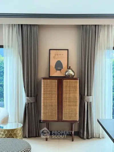Stylish living room with elegant curtains and chic cabinet, perfect for modern home decor.