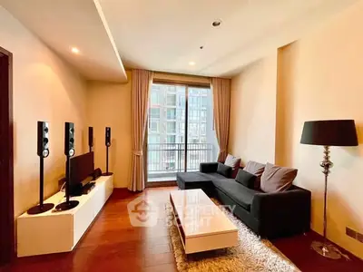 Modern living room with sleek furniture and large window offering city view