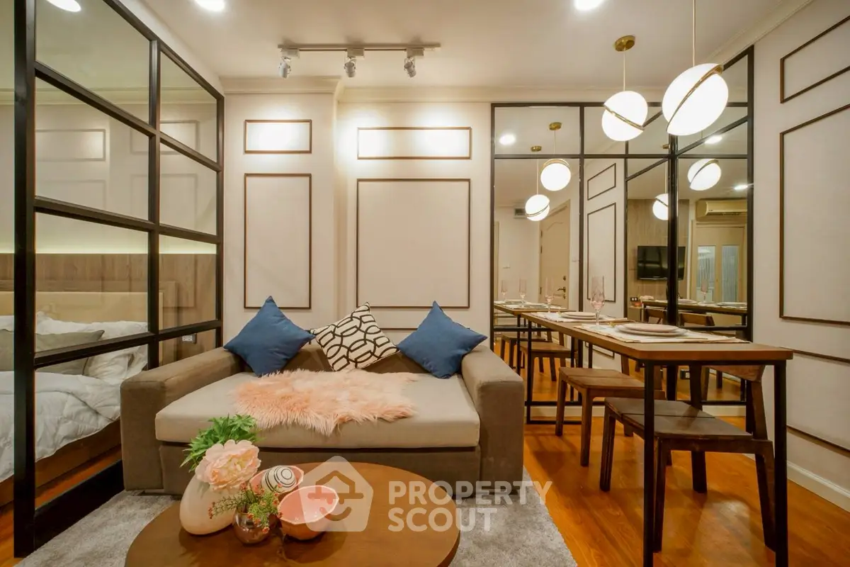 Stylish living room with modern decor and cozy ambiance, featuring elegant lighting and a chic dining area.