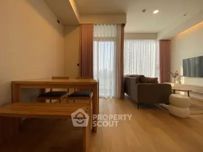Modern living room with wooden dining set and cozy seating area, featuring floor-to-ceiling windows.