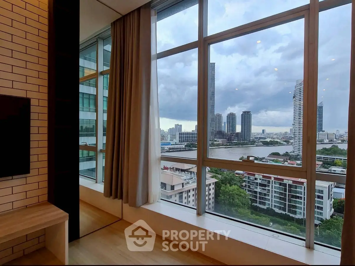 Stunning cityscape view from a modern high-rise apartment window, showcasing urban skyline and river.