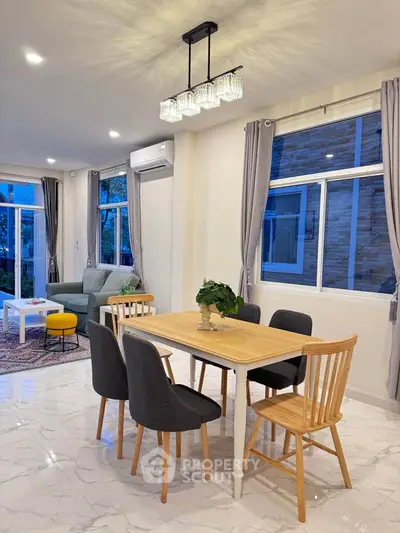 Spacious modern living room with elegant dining area and large windows for natural light.