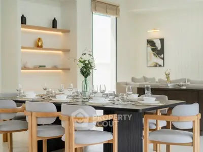 Elegant dining area with modern decor and stylish furniture in a bright open space.