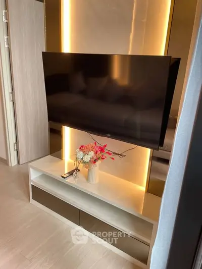 Modern living room with sleek TV setup and elegant lighting