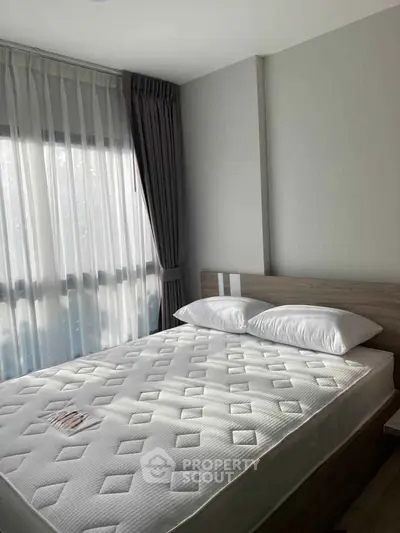 Bright and cozy bedroom with modern design and ample natural light.