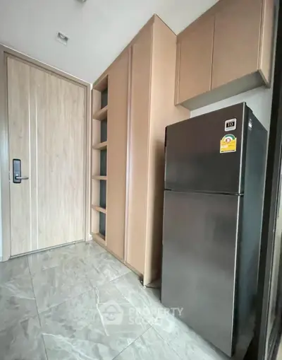 Modern kitchen with sleek fridge and ample storage space