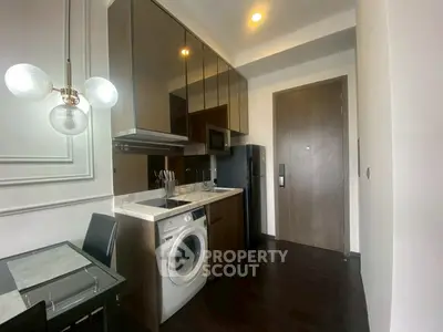 Modern kitchen with sleek cabinetry and built-in washing machine