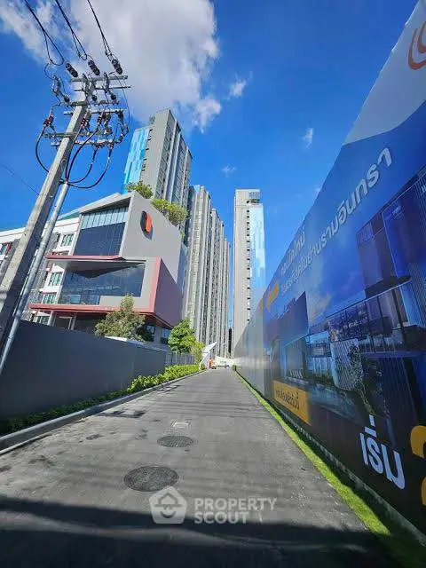 Modern high-rise buildings with clear blue sky and street view