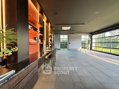 Spacious modern living room with large windows and stylish decor, perfect for entertaining.