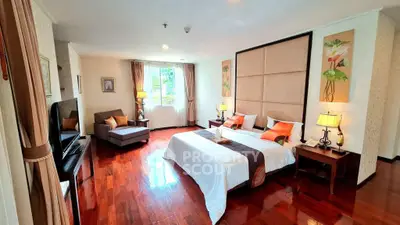 Luxurious bedroom with elegant decor and hardwood floors