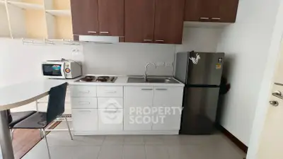 Modern compact kitchen with sleek cabinets and stainless steel appliances