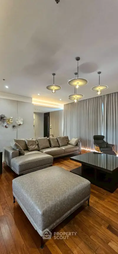 Luxurious living room with elegant lighting and plush seating, perfect for relaxation and entertainment.