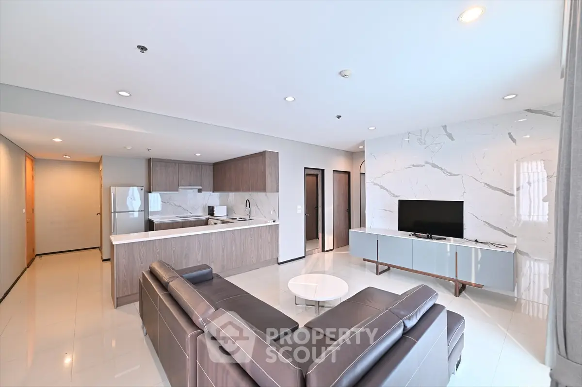 Spacious modern living room with open kitchen and sleek furnishings