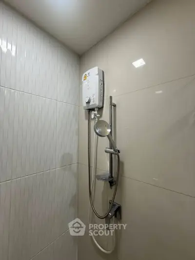 Modern bathroom with sleek shower and water heater, perfect for a contemporary home.