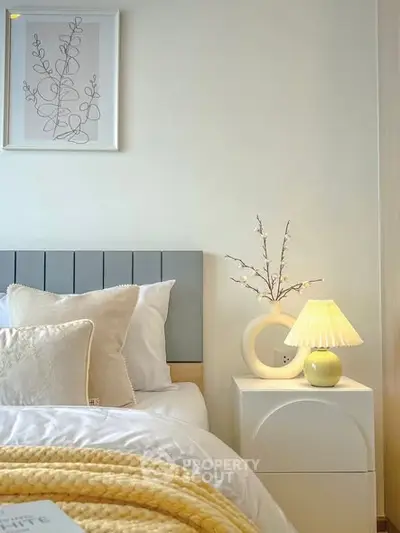 Cozy bedroom with stylish decor and soft lighting, perfect for relaxation.