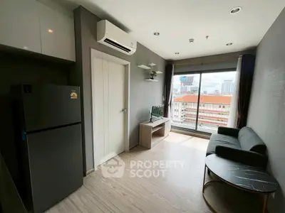 Modern living room with city view, sleek furniture, and natural light.