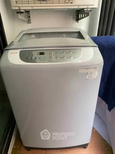 Modern washing machine in a well-lit laundry area, perfect for efficient home living.